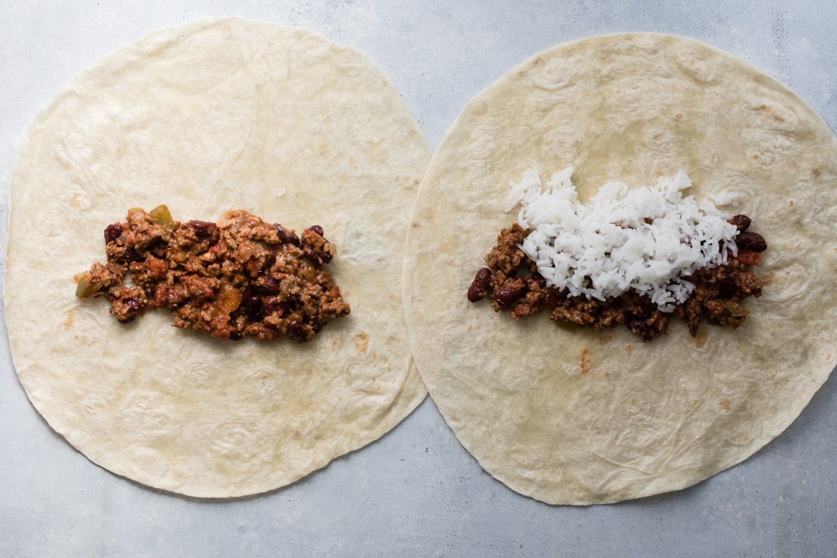 Chili and rice on flour tortillas for burritos.