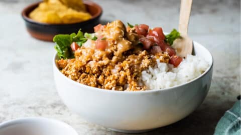 A white bowl with rice and Chipotle Sofritas.