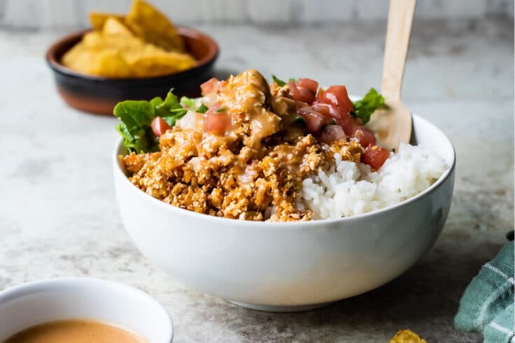 A white bowl with rice and Chipotle Sofritas.
