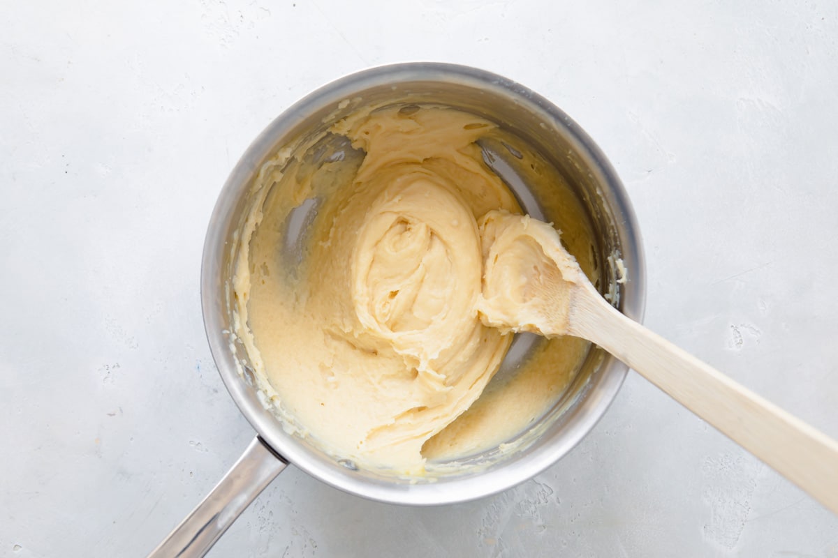 Pate-choux dough for cream puffs in a mixing bowl.