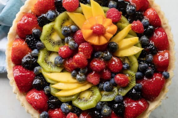 A fresh fruit tart on a counter top.