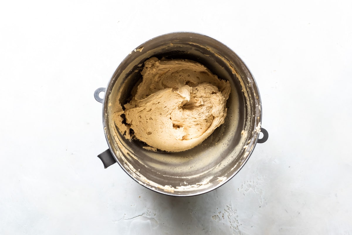 A mixing bowl filled with peanut butter frosting.