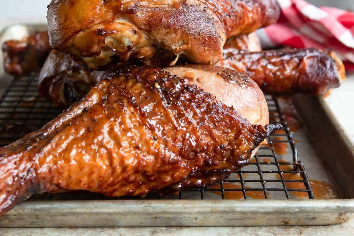 Smoked turkey legs on a baking rack.