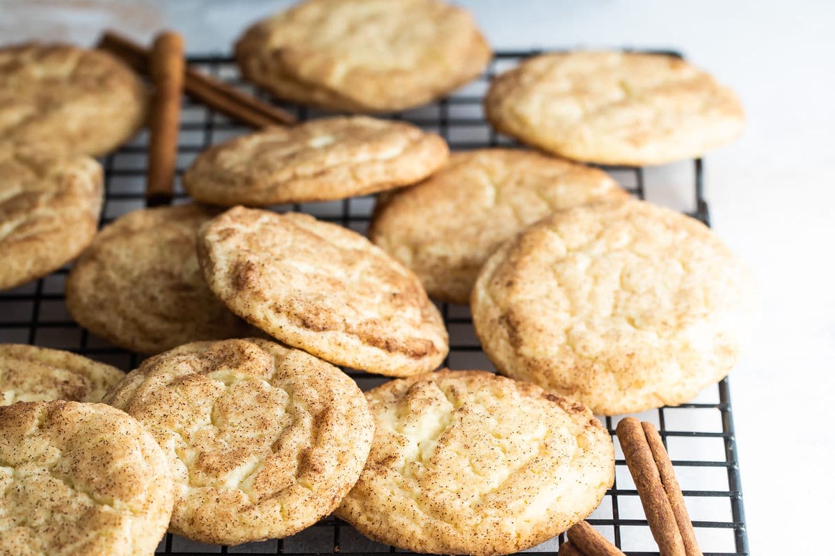 Snickerdoodle cookies on a baking rack.