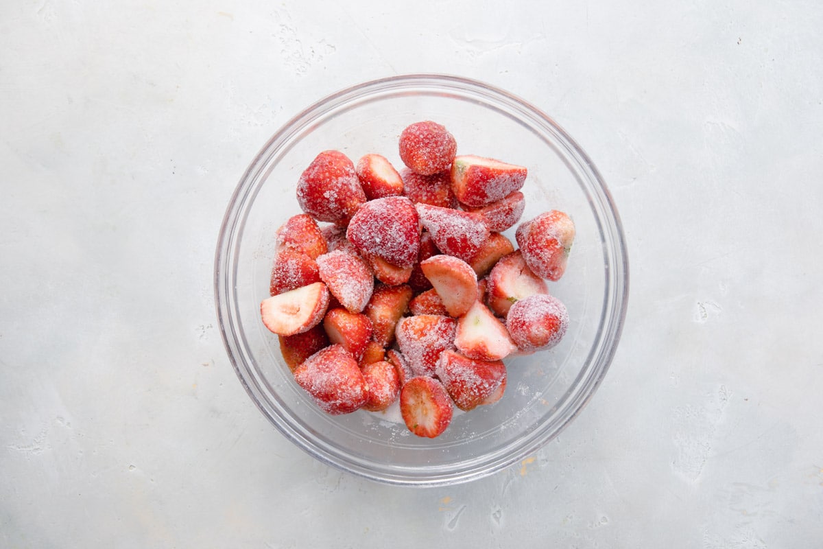 A bowl of strawberries with sugar and spices.