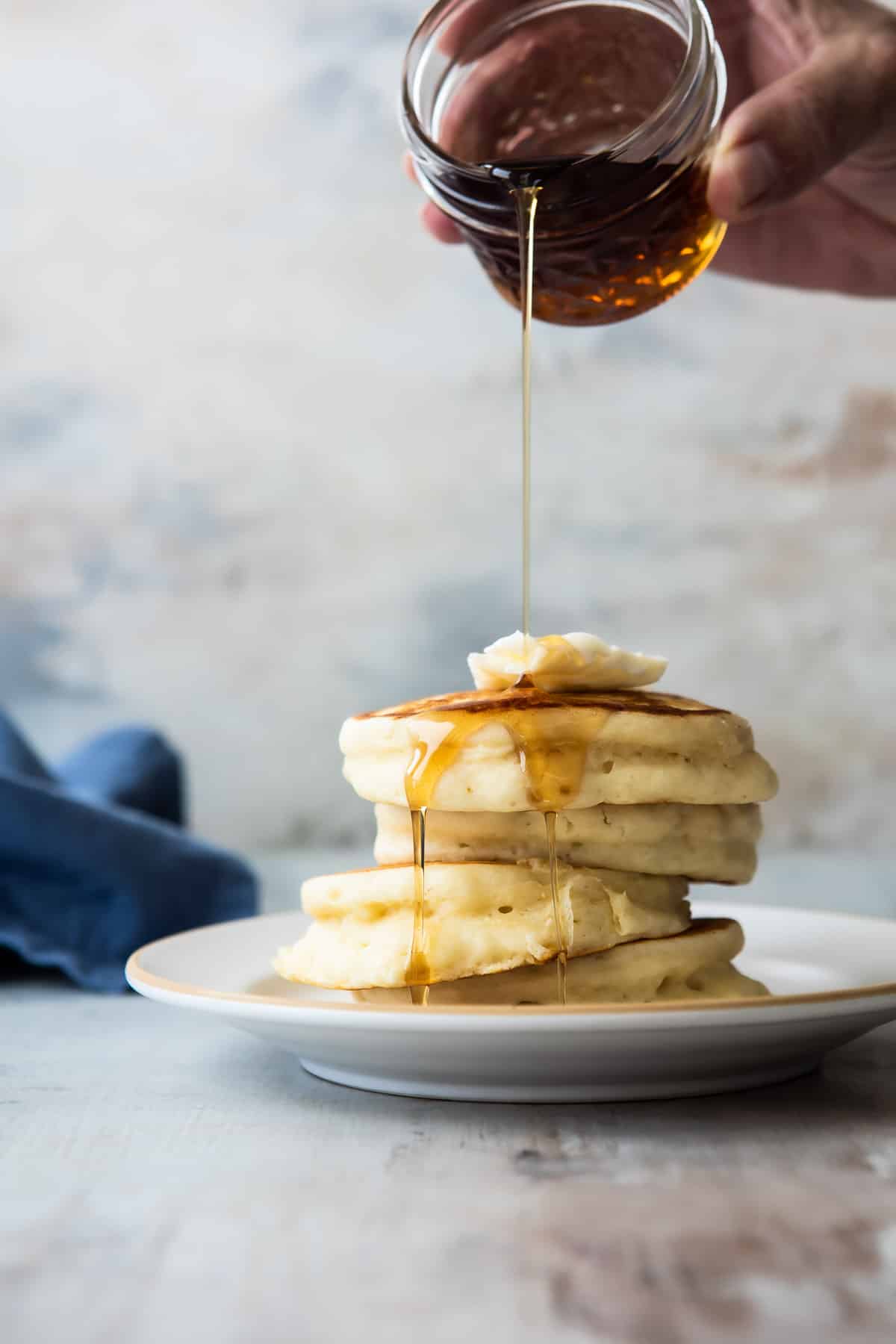 A stack of buttermilk pancakes on a plate.