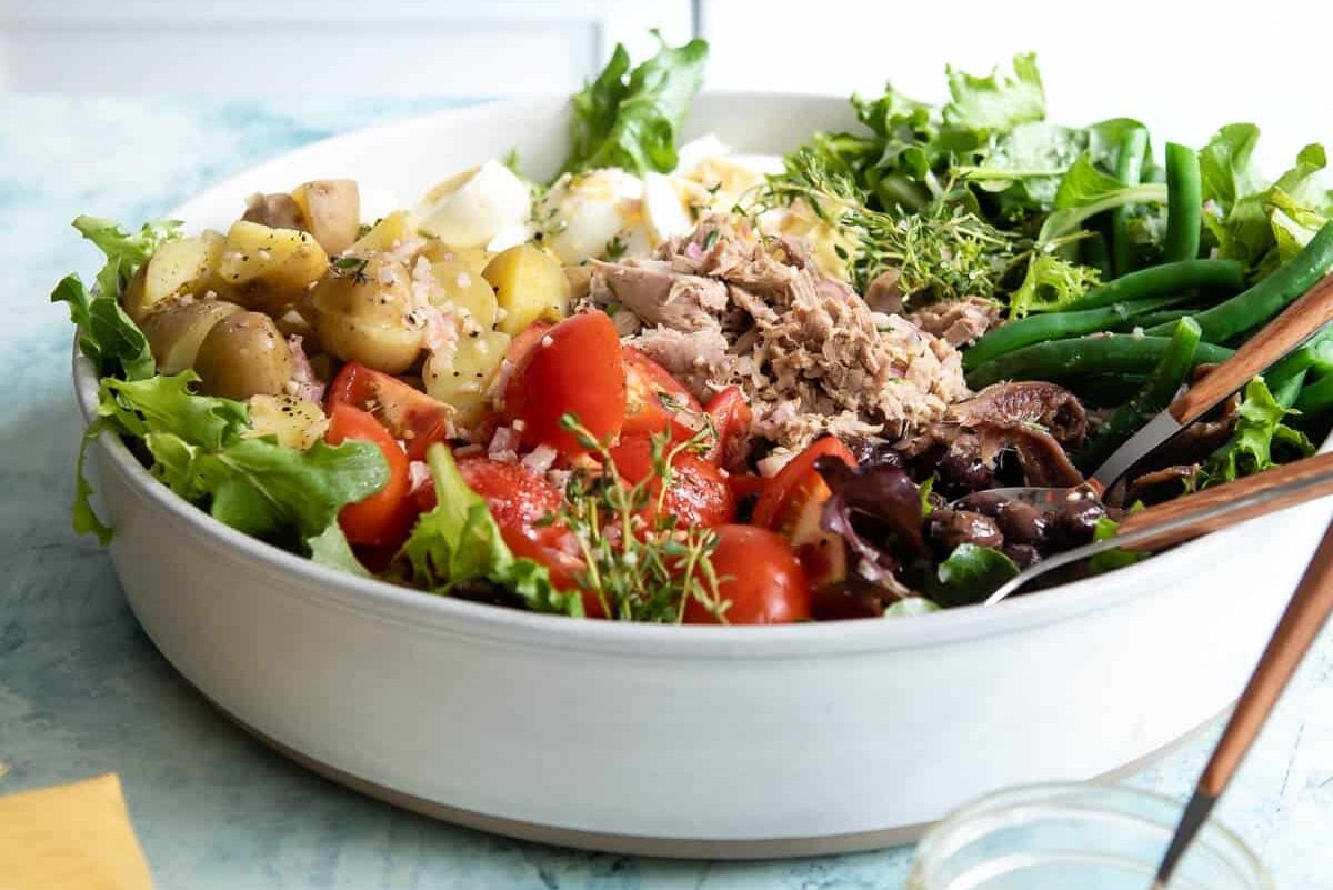 A large serving bowl with Niçoise Salad.