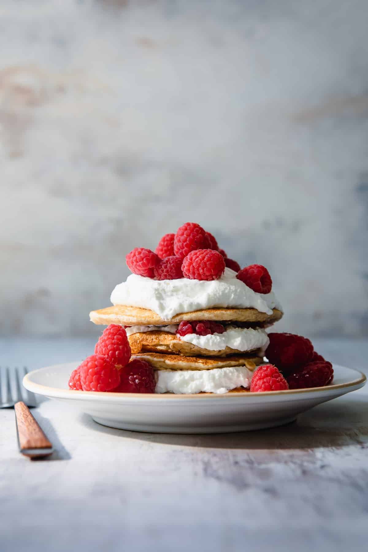 A stack of oatmeal pancakes on a plate.