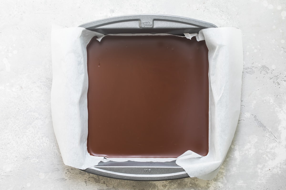 Melted chocolate hardened in a square baking pan.