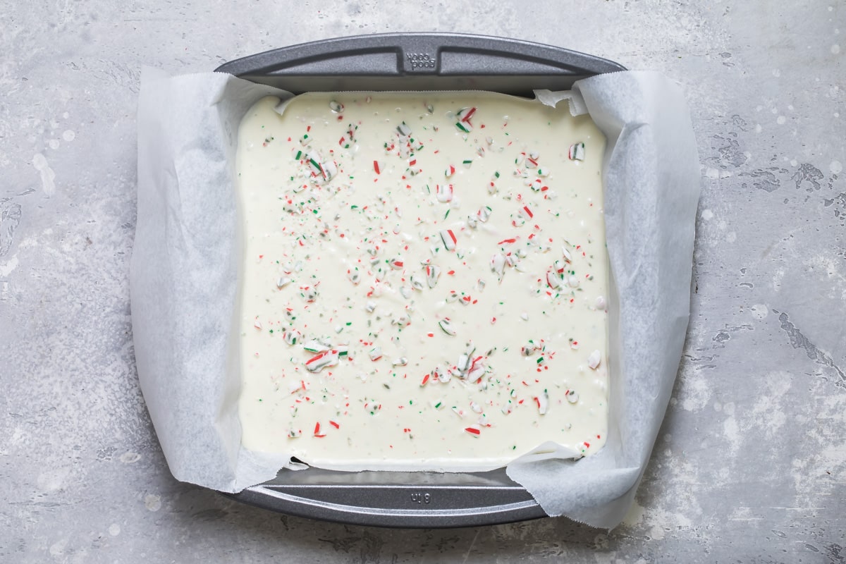 Peppermint bark in a square baking pan.