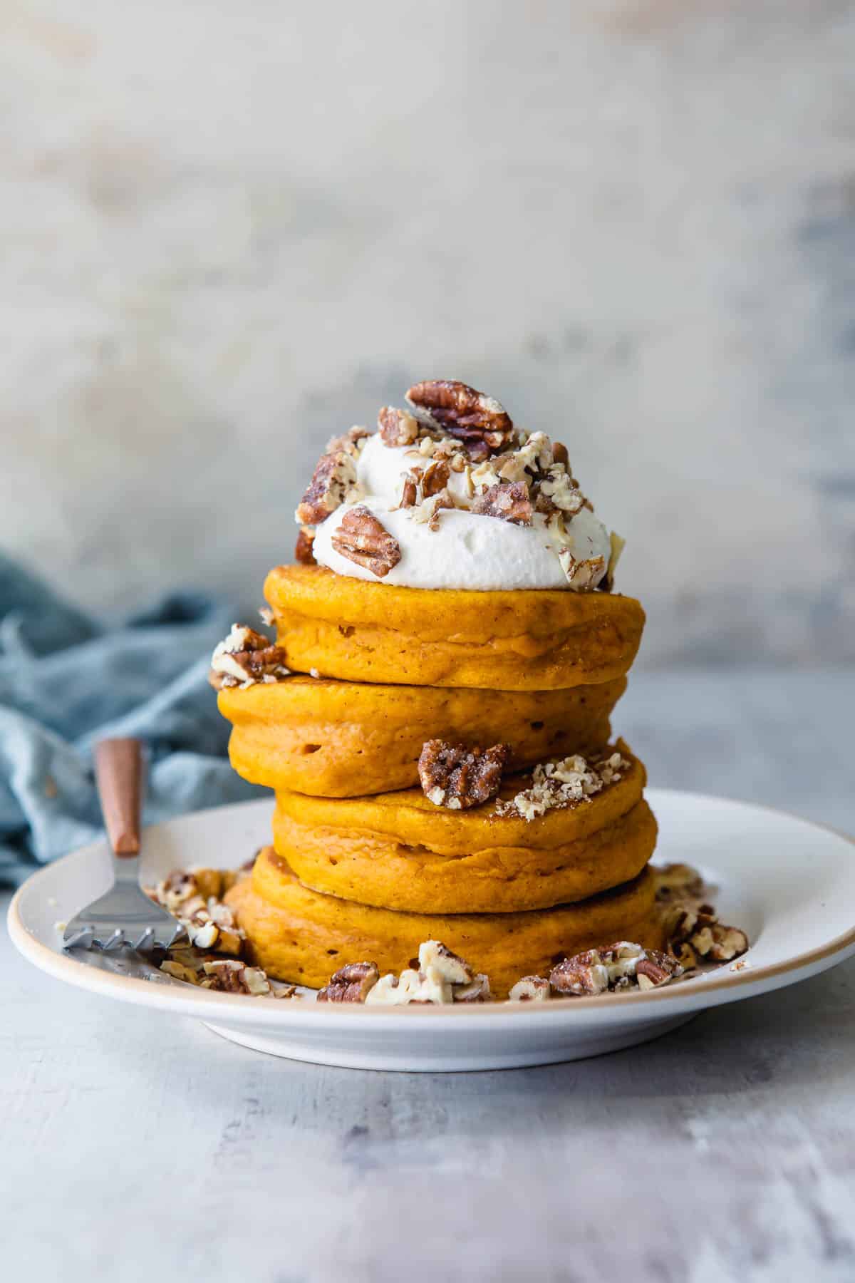 A stack of pumpkin pancakes on a plate.