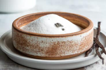 Vanilla sugar in a brown bowl.