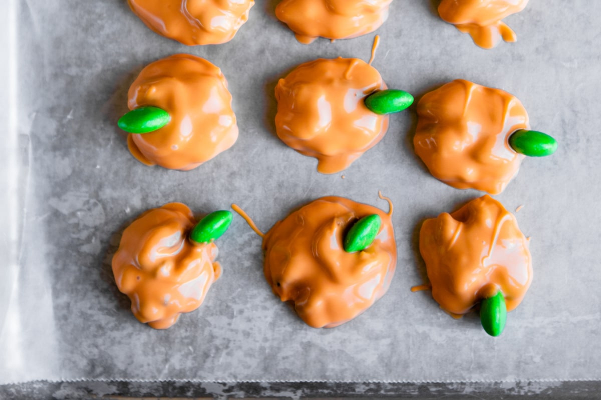 Walnuts dipped in candy coating to look like pumpkins.