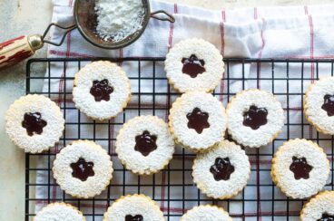 Linzer cookies on a cooling rack.