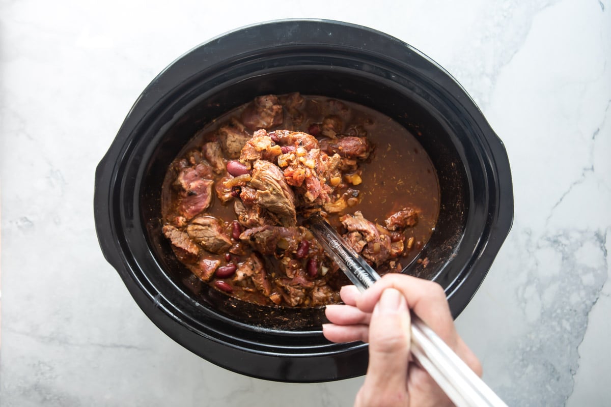 A slow cooker full of chili con carne.