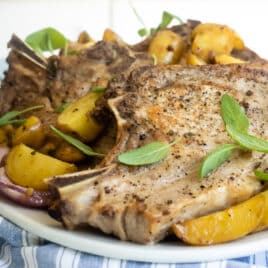A plate with pork chops and potatoes.