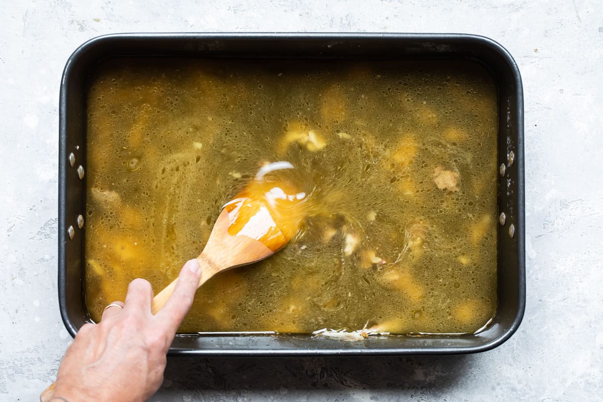 Stirring pan drippings form roasted chicken.