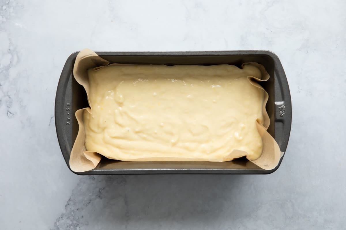 Lemon yogurt cake batter in a loaf pan.