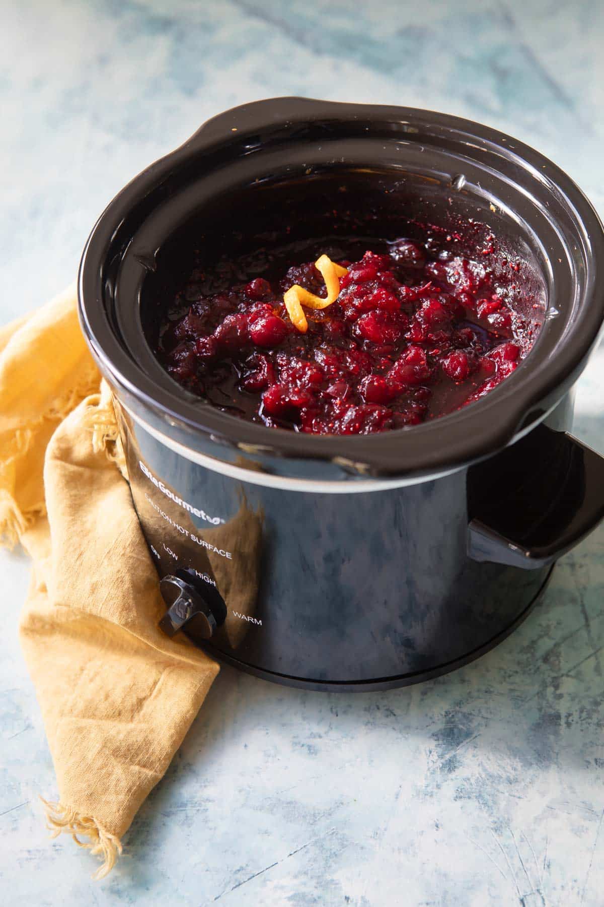 A slow cooker full of cranberry sauce.