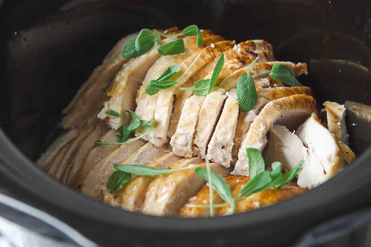Slow cooker turkey breast slices in a crockpot.
