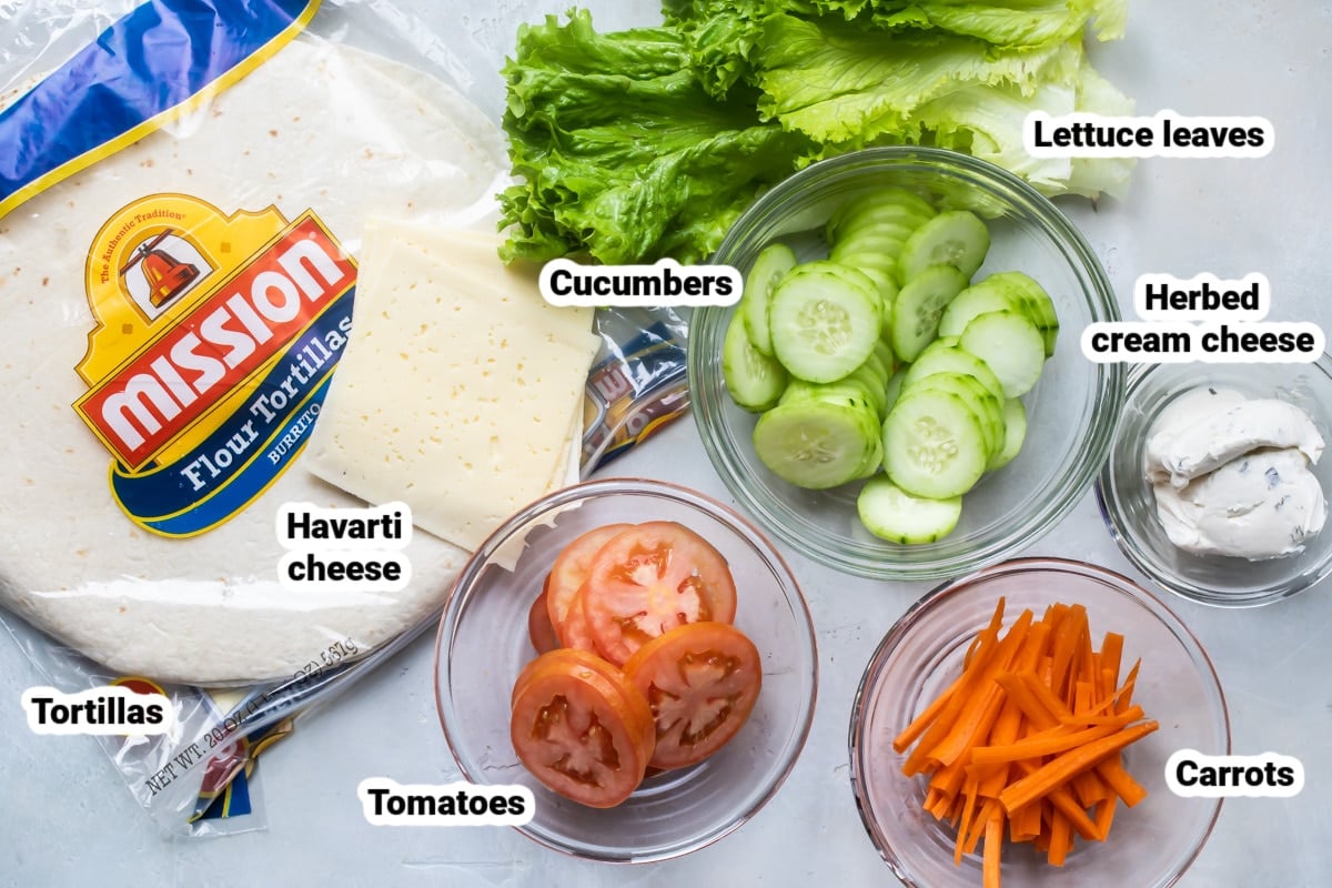 Labeled veggie wrap ingredients in bowls.