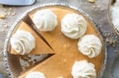 A no-bake pumpkin cheesecake with whipped cream on top.