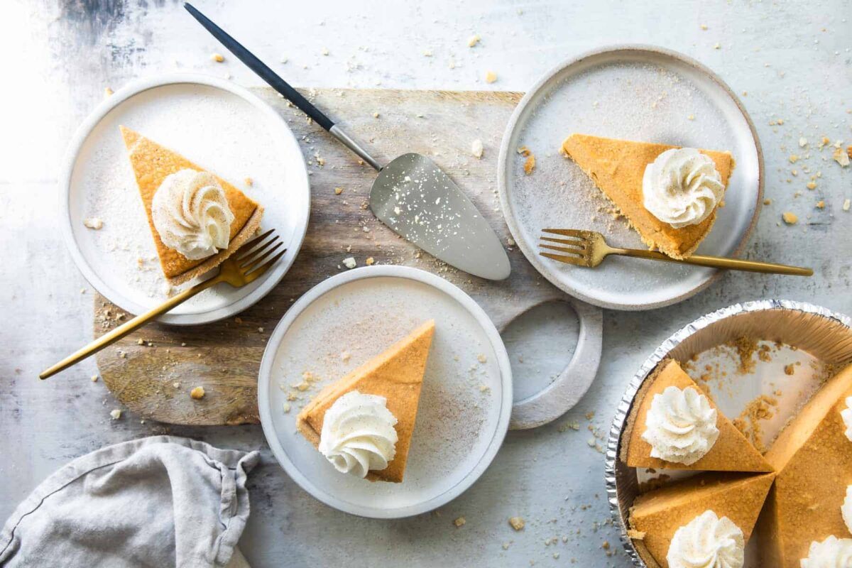 Slices of no-bake pumpkin cheesecake on plates.