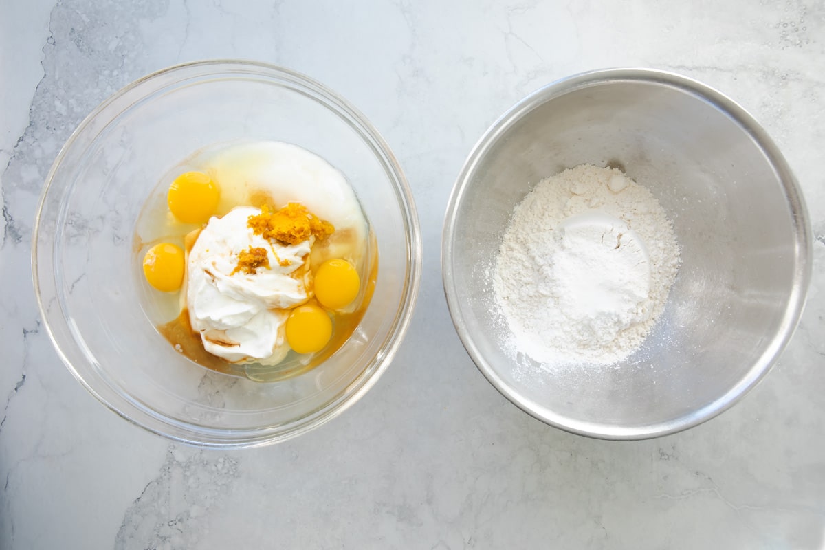 Ingredients to make orange cake in bowls.