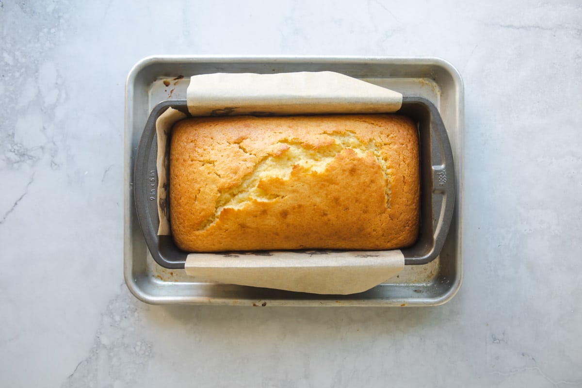A baked orange cake in a loaf pan.