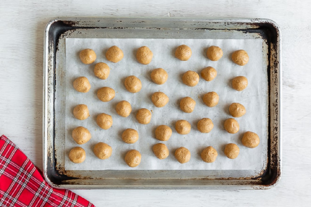 A baking sheet full of peanut butter buckeye balls.
