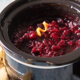 A slow cooker filled with cranberry sauce.
