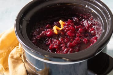 A slow cooker filled with cranberry sauce.