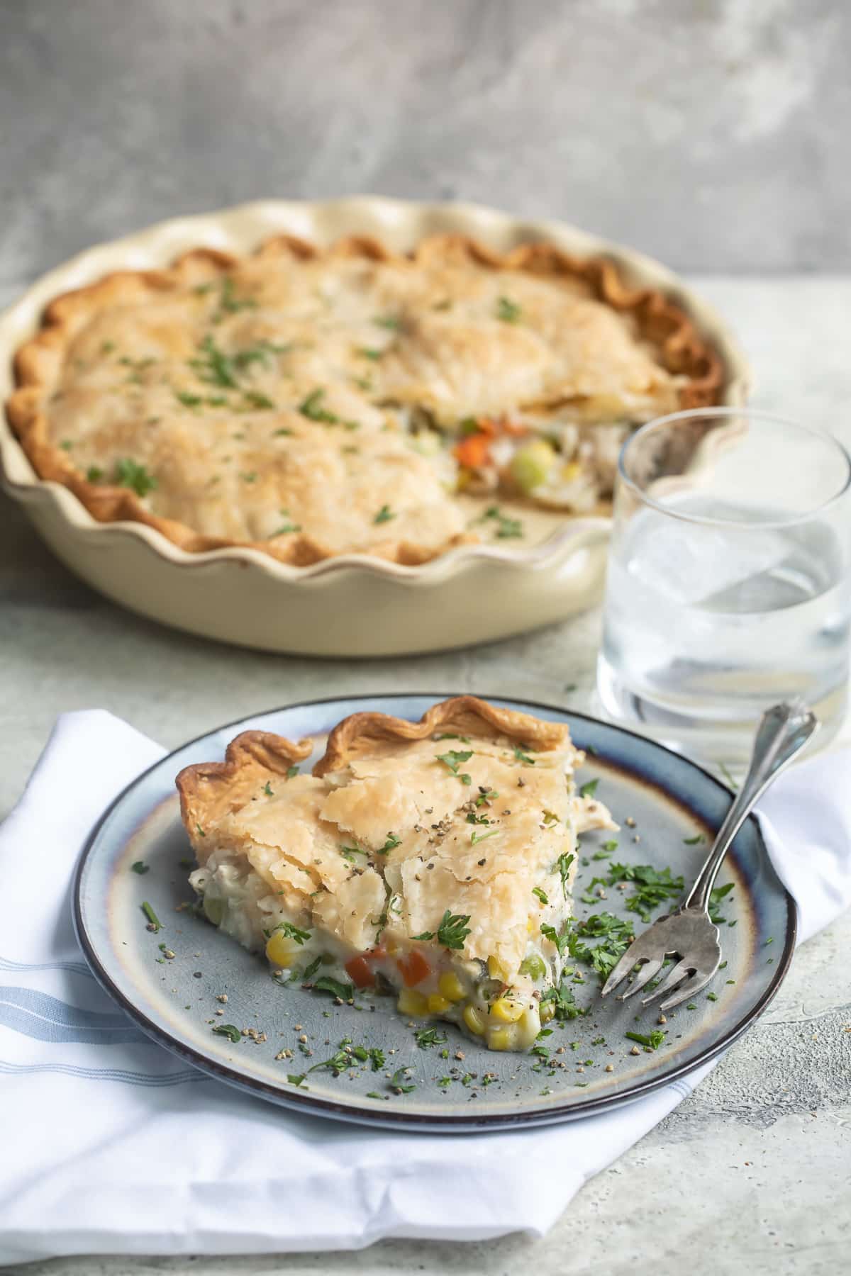 Turkey pot pie with a slice taken out and set on a plate.