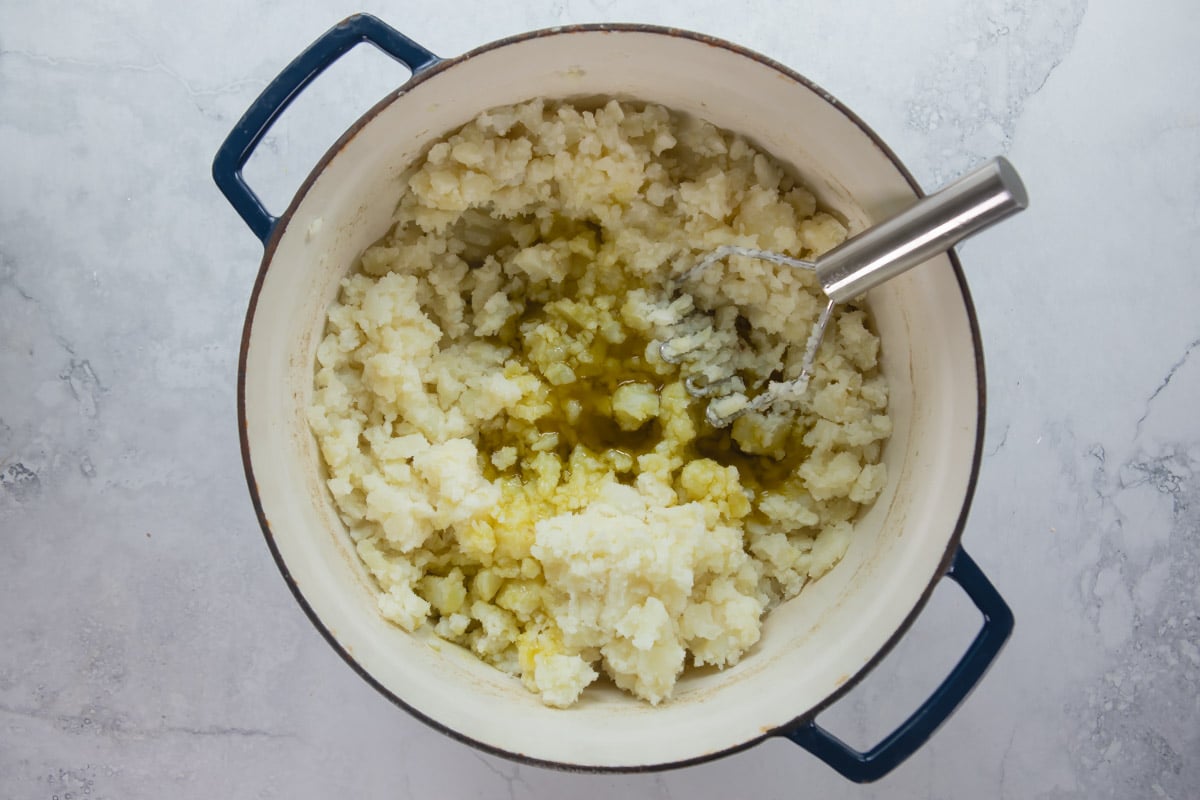 Mixing vegan mashed potatoes.