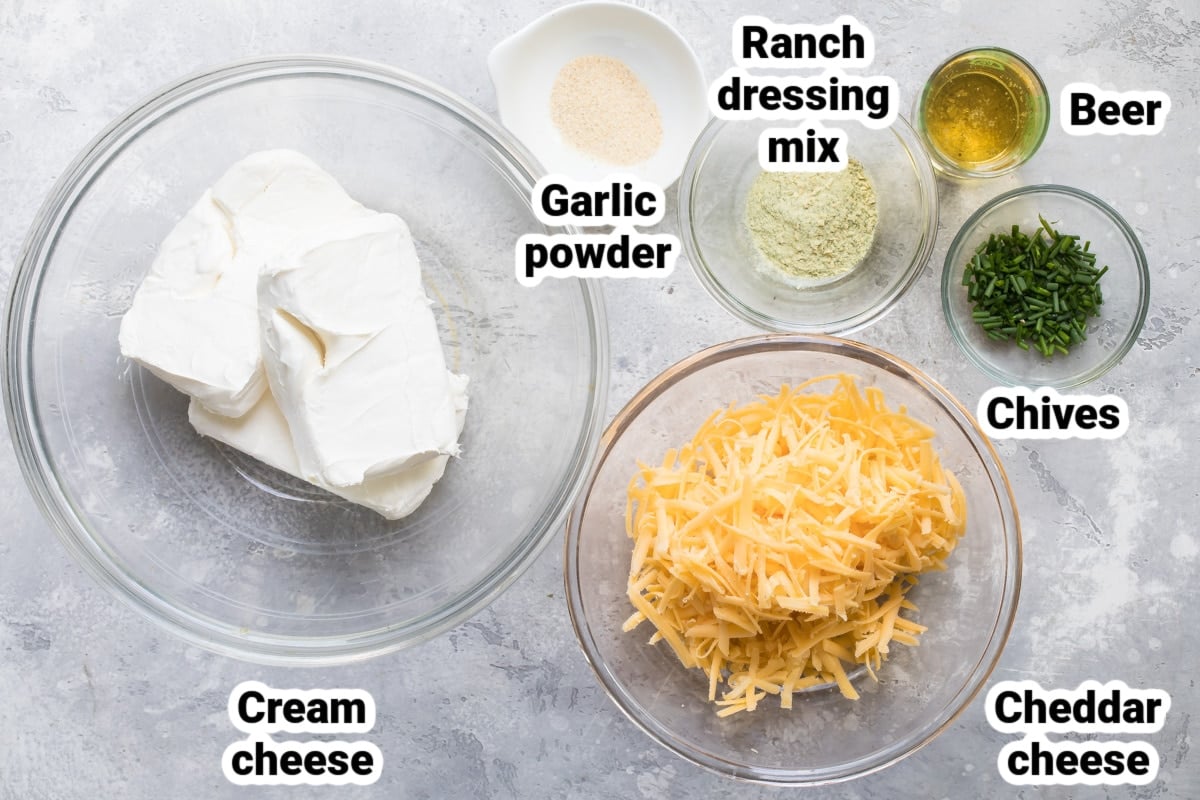 Labeled beer cheese dip ingredients in various bowls.