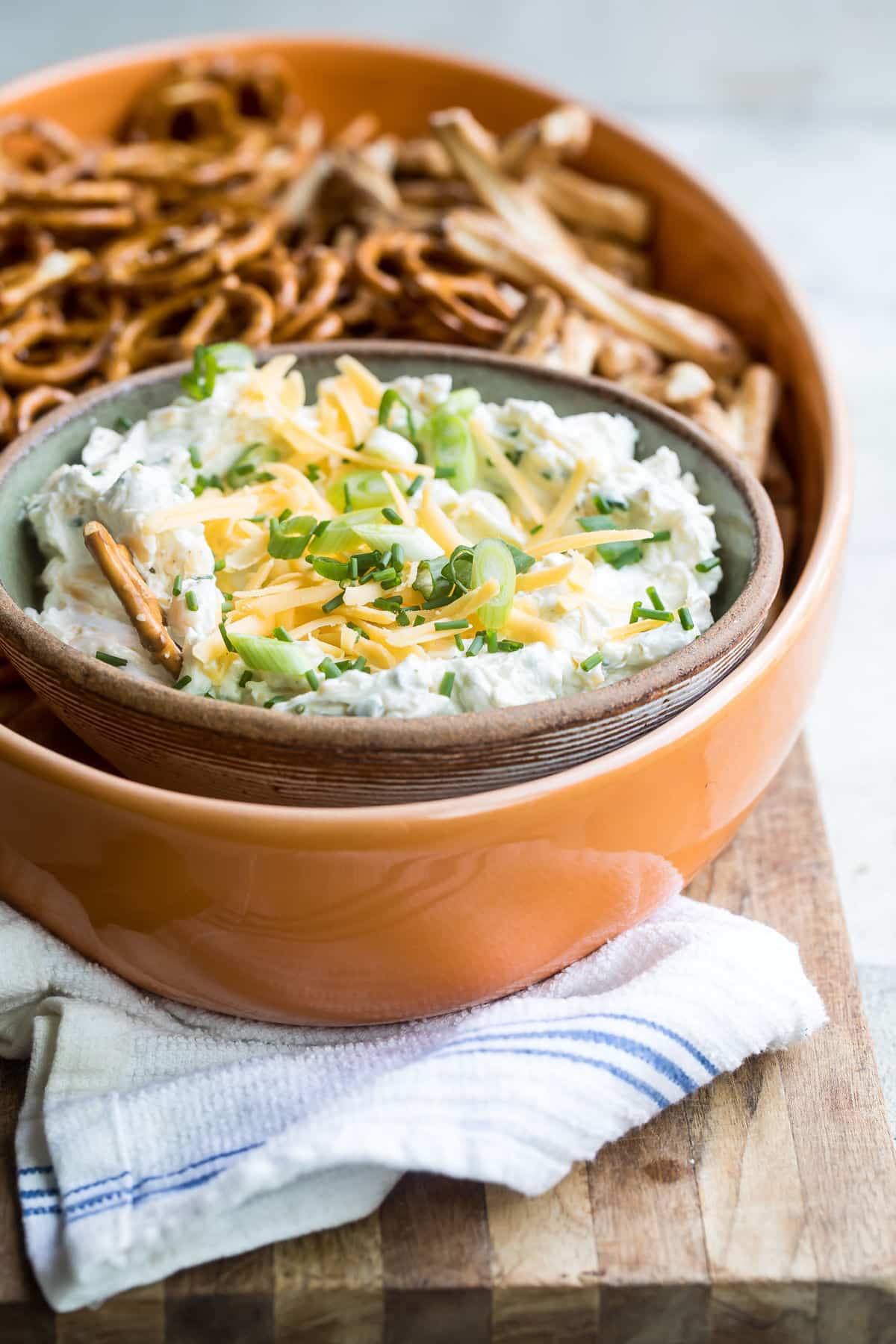 Beer cheese dip in a bowl with pretzels.