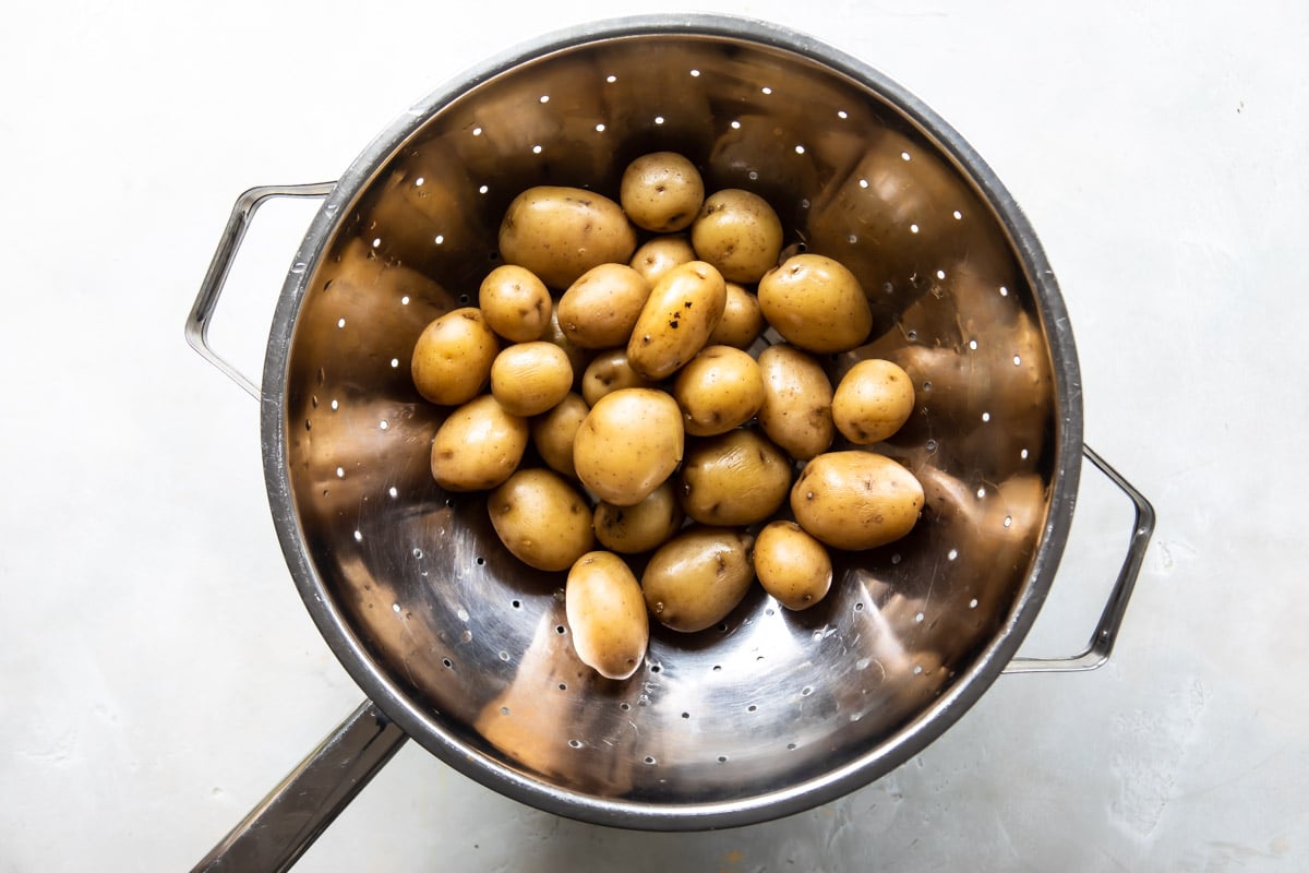 Boiled potatoes in a colander draining.