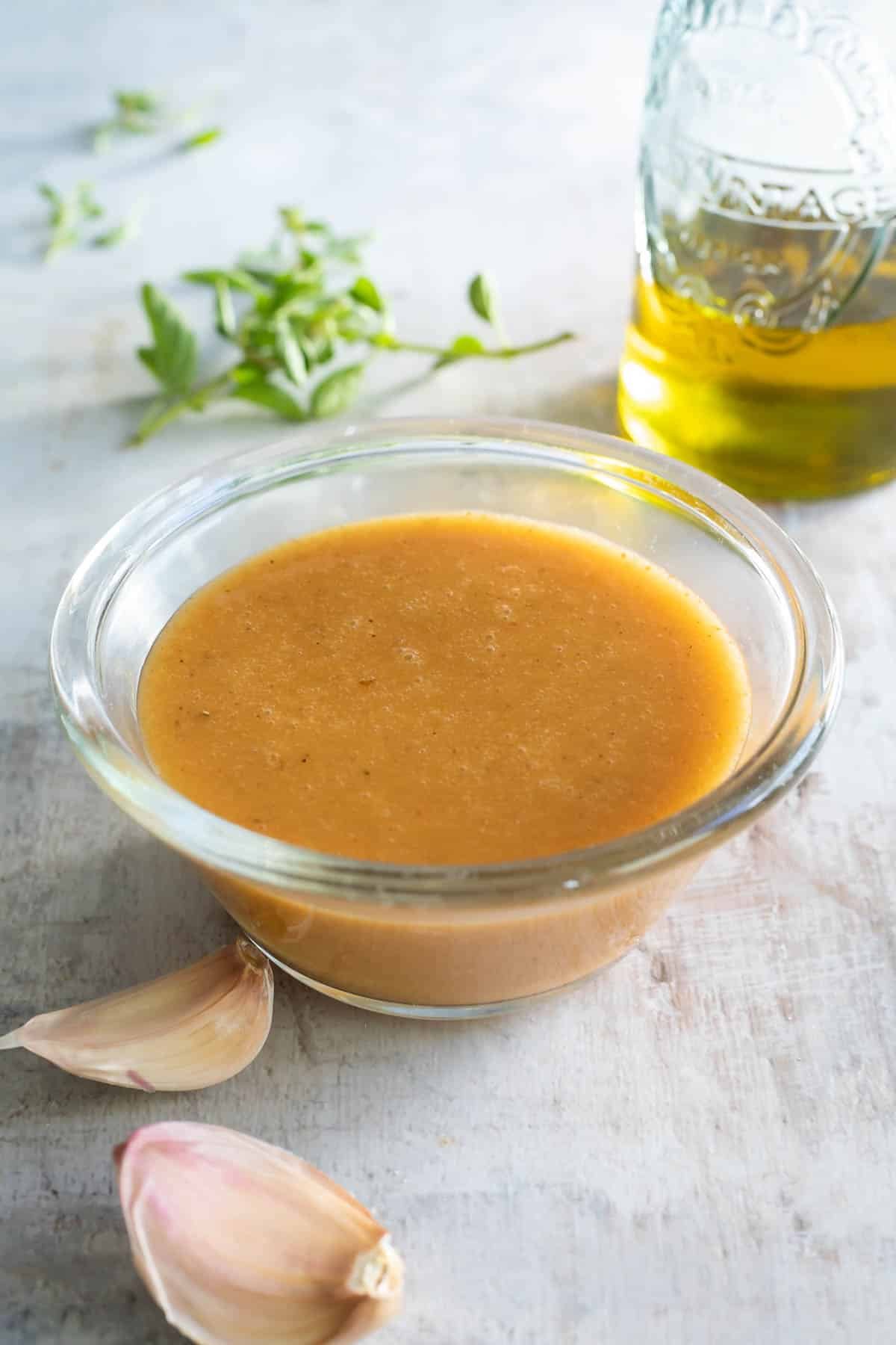 Chipotle vinaigrette in a clear bowl on a countertop.