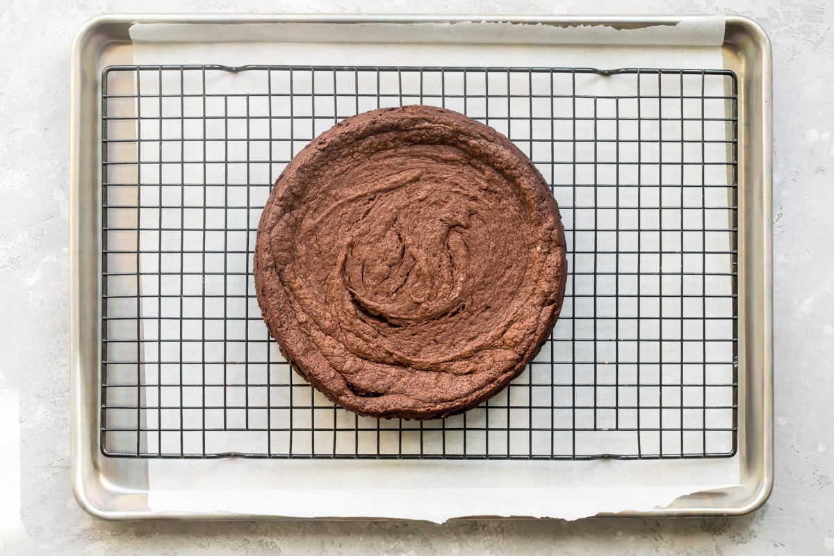Flourless chocolate cake on a cooling rack.