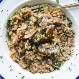 A white bowl full of mushroom risotto.
