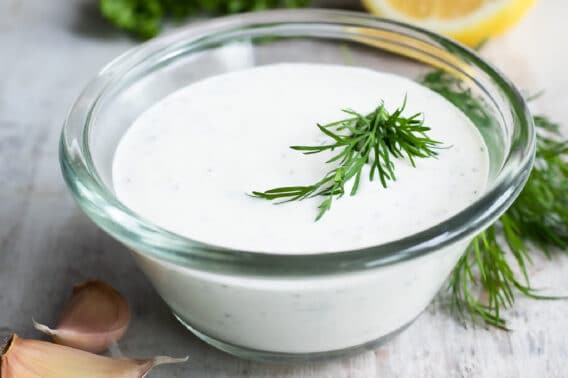 Ranch Dressing in a clear glass dish on a countertop.