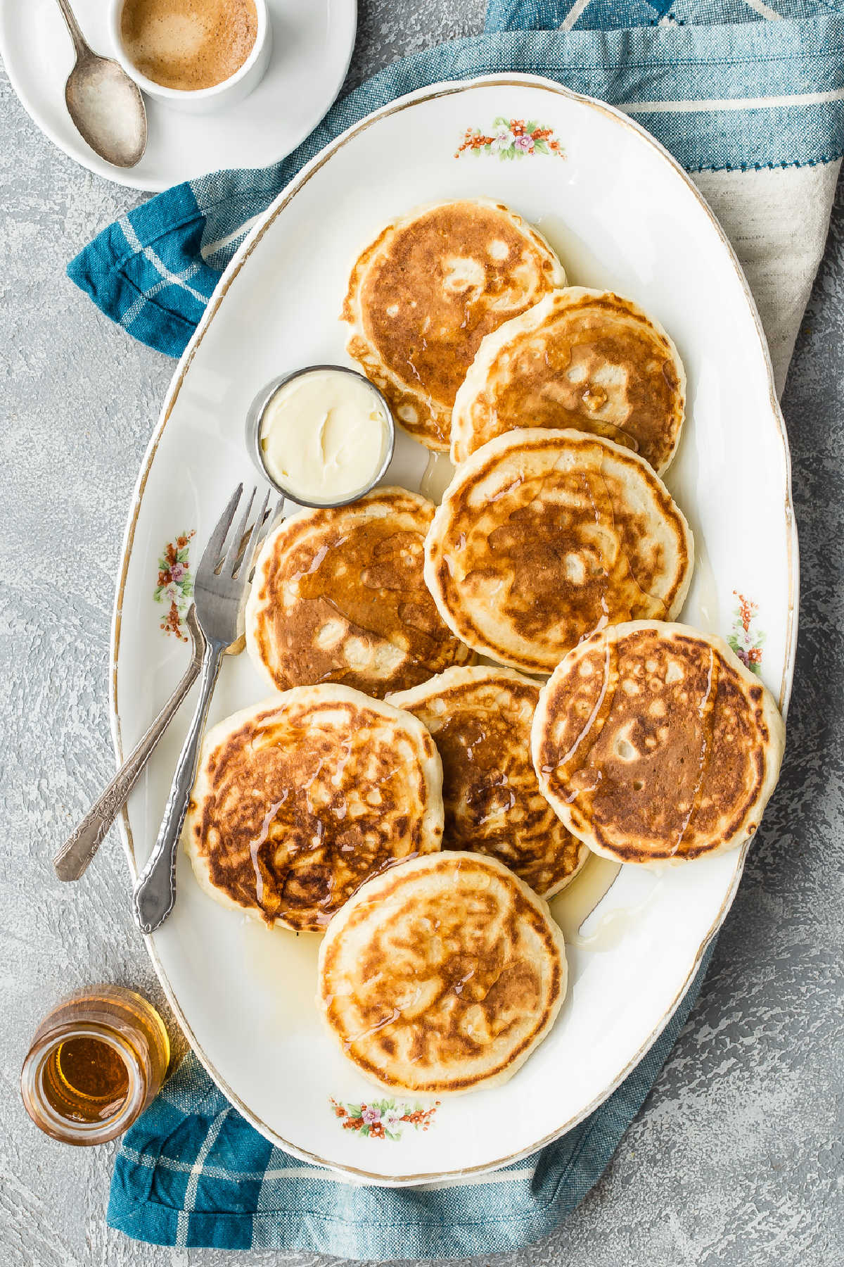 A platter of vegan pancakes with maple syrup on top.