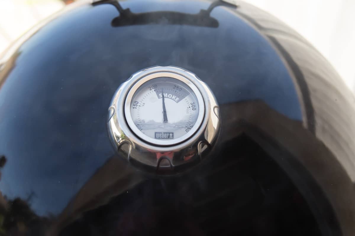 The temperature gauge on a charcoal smoker.