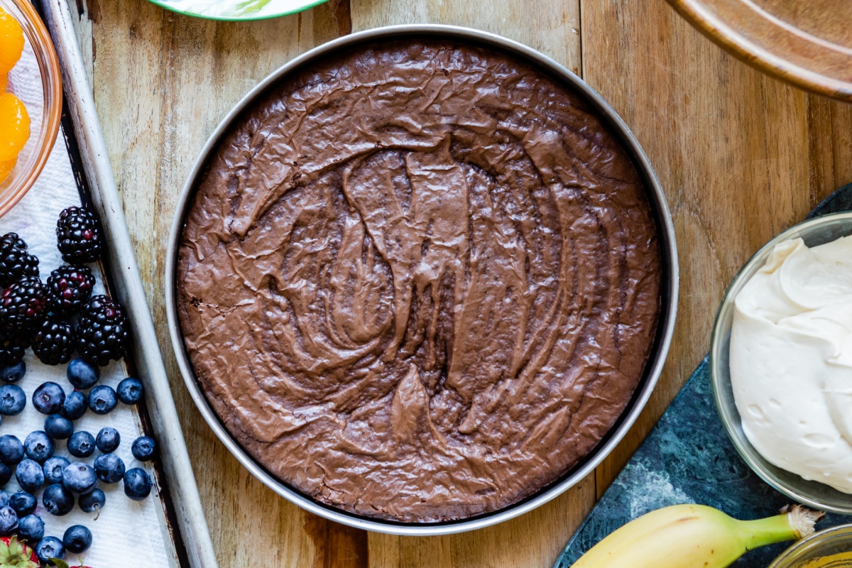 A round pan with baked brownie inside.