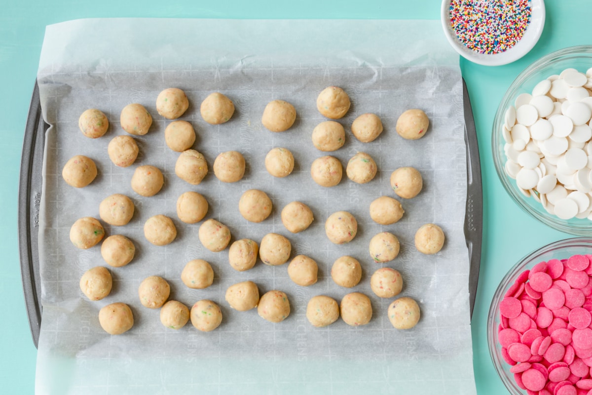 A tray of cookie truffle batter rolled into balls.