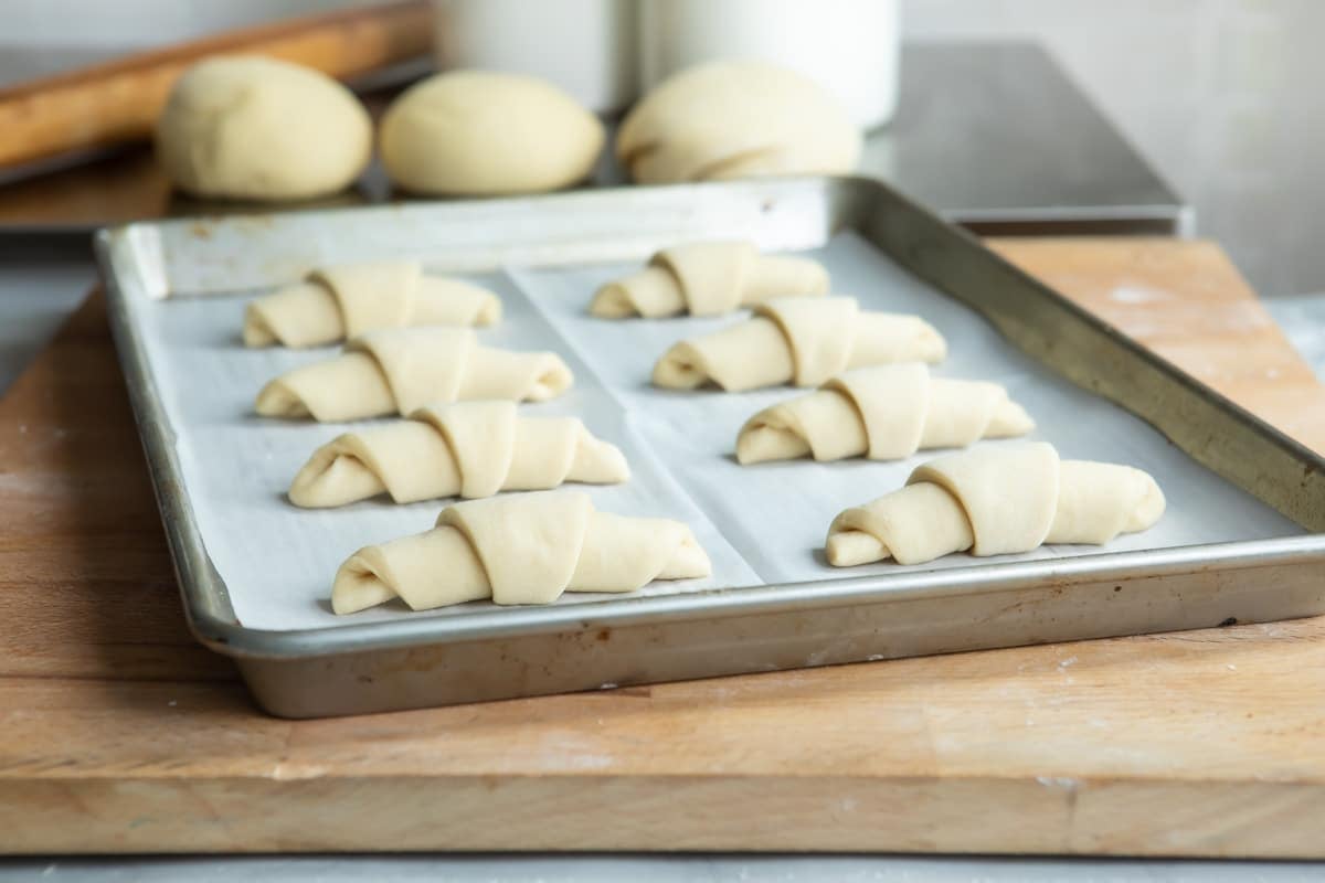 8 crescent rolls on a baking sheet, unbaked.