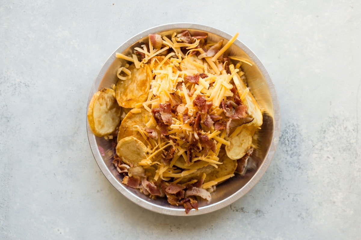Potato nachos in a bowl before broiling in the oven.