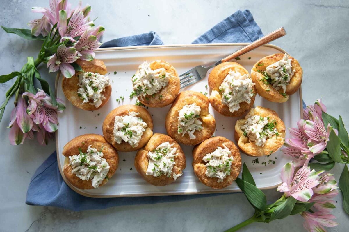 Baked popovers filled with chicken salad in a muffin pan.