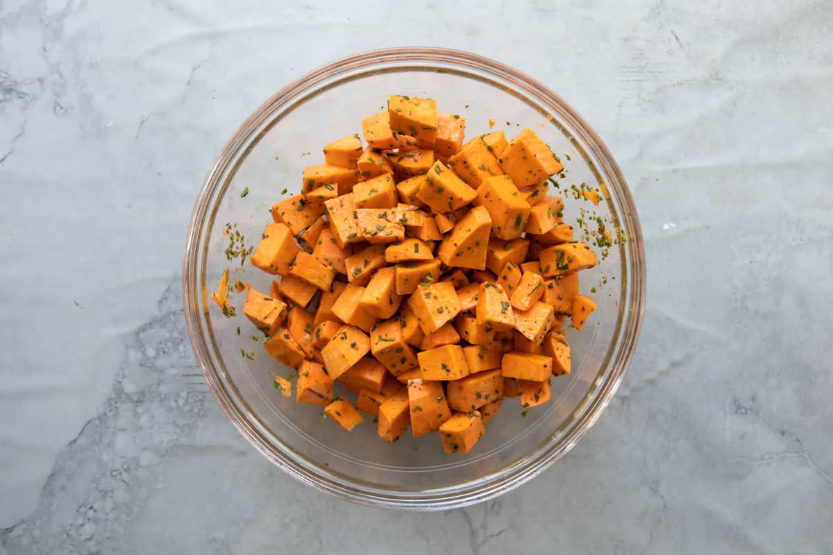 A bowl of cubed raw sweet potatoes.