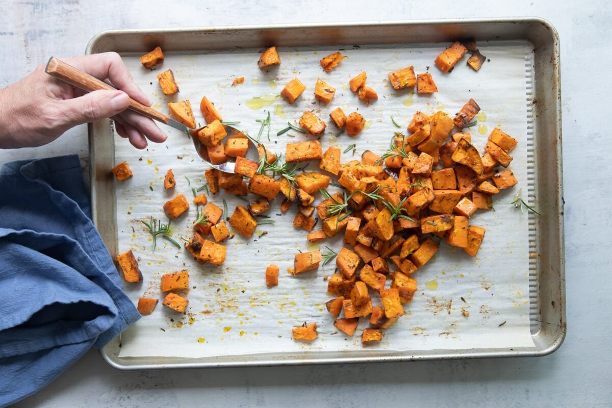 A sheet pan of cubed roasted sweet potatoes.
